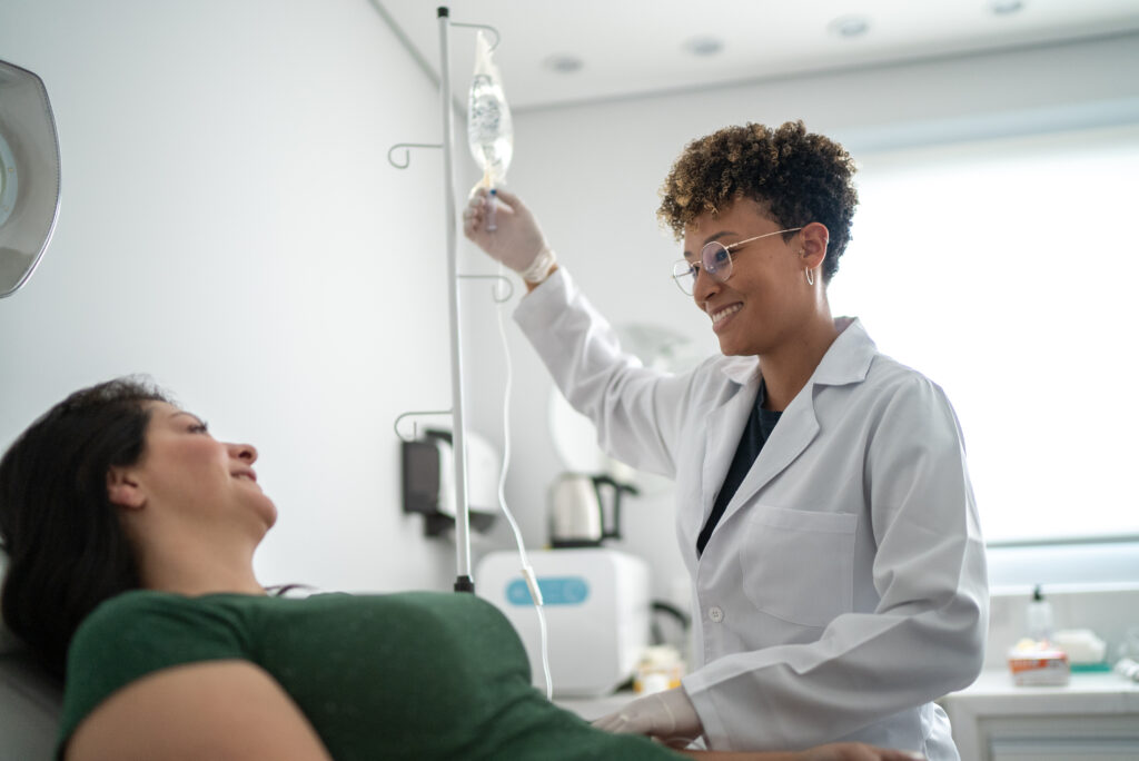 Doctor talking with a patient and taking IV drip at a medical clinic